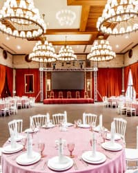 A wedding reception room dressed for guests